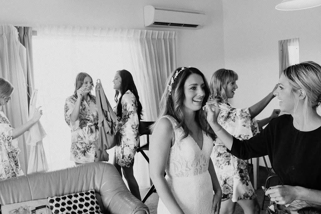 Black and white photograph of bridal makeup preparations