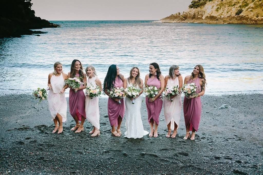 Bride and bridal party beside the sea